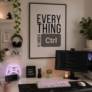May include: A framed wall poster with black text on a white background that reads EVERYTHING IS UNDER Ctrl. The poster is displayed above a desk setup featuring a computer monitor, a white mechanical keyboard, a mouse, and various gaming accessories.