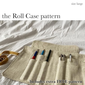 May include: A beige linen roll case pattern with the text "the Roll Case pattern" and "Includes extra FREE pattern". The case holds several pens and small tools. The size is large.