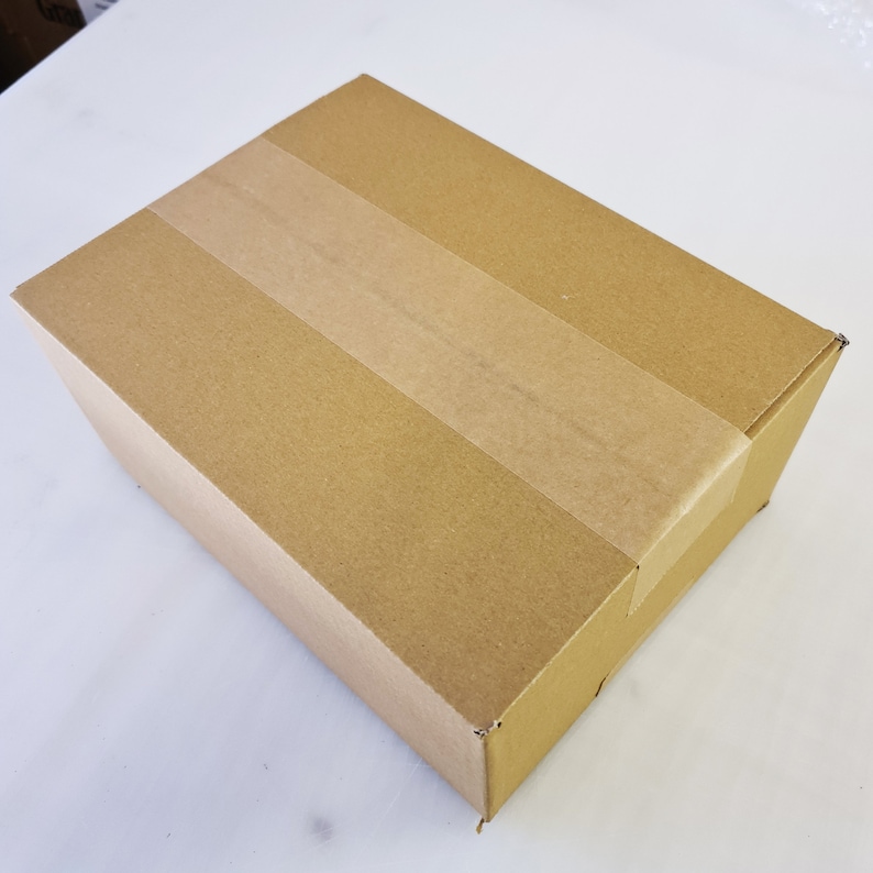 May include: A plain brown cardboard box with a single strip of tape across the top.