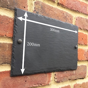 May include: Black slate sign with white text and arrows indicating dimensions. The sign measures 200mm by 300mm.