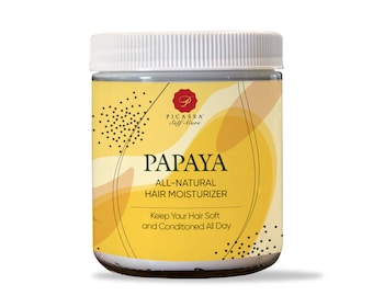 May include: A white jar with a yellow label that says "PAPAYA ALL-NATURAL HAIR MOISTURIZER Keep Your Hair Soft and Conditioned All Day". The label also has a black and white design with a small logo that says "PICASSA Self-Care".