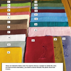 May include: A collection of 23 fabric swatches in various colors, numbered 1 through 23. The swatches are arranged in rows, with the numbers displayed on the left side of the image. The last three swatches have embroidered designs on them.