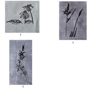 May include: Five embroidered designs on a light gray linen fabric. The designs include a daisy, leaves, and grass.
