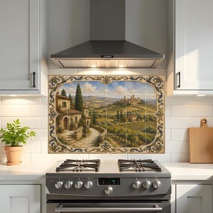 May include: A rectangular wall mural composed of multiple ceramic tiles featuring a painted landscape of a Tuscan villa, rolling hills, vineyards, and a distant hilltop town, all framed by an ornate blue and gold decorative border pattern.