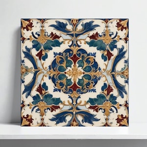 May include: Square decorative tile with a symmetrical floral design. The pattern features blue, teal, gold, and burgundy elements on an off-white background. The tile is likely ceramic or porcelain.