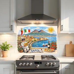 May include: A decorative kitchen backsplash tile mural featuring a colorful illustration of Naples, Italy. The scene includes Mount Vesuvius, the coastline, a Pulcinella character playing a mandolin, a pizza, wine, and the text NAPOLI.