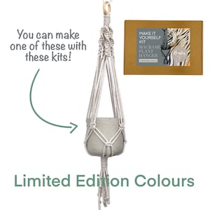 May include: A white macrame plant hanger kit with a beige cardboard box. The box has the text "Make It Yourself Kit Macrame Plant Hanger Limited Edition Colours" and a small image of a plant in a macrame hanger. The text "You can make one of these with these kits!" is written above the image. The text "Limited Edition Colours" is written below the image.