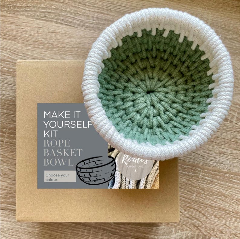 May include: Make it yourself kit for a rope basket bowl. The kit includes a white and green rope basket bowl, a brown box with the text "Make it yourself kit" and "Rope Basket Bowl" and a small tag with the text "Rontes Creations".