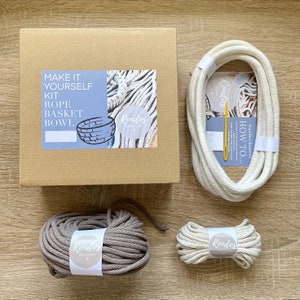May include: A DIY rope basket bowl kit with instructions, two spools of rope, one in beige and one in gray, and a needle. The kit is packaged in a brown cardboard box with the text "Make it yourself kit Rope Basket Bowl" and the brand name "Rondos Creations".