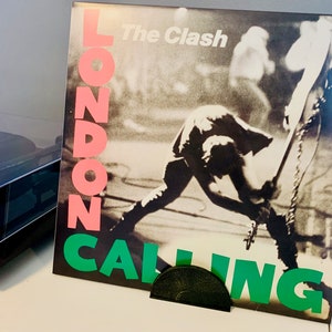 Now Playing record stand minimalist style holding vinyl record in black color