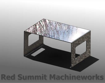 May include: A rectangular metal table with a reflective top. The table has a simple, modern design with cut-out sides. The Red Summit Machineworks logo, a red wolf head in a gear, is in the upper left corner.