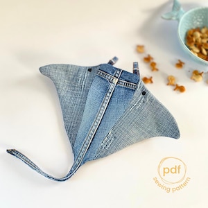 May include: A denim blue stingray sewing pattern. The pattern is made from recycled denim and has a simple, modern design. The pattern is available as a PDF download.