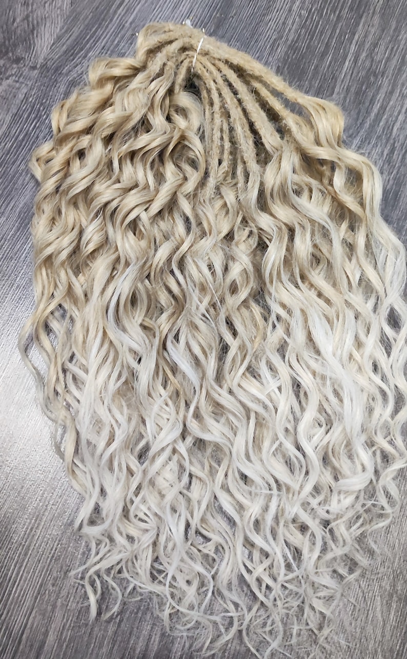May include: A set of blonde and white ombre curly synthetic dreadlocks. The dreadlocks are made of kanekalon hair and are approximately 24 inches long.