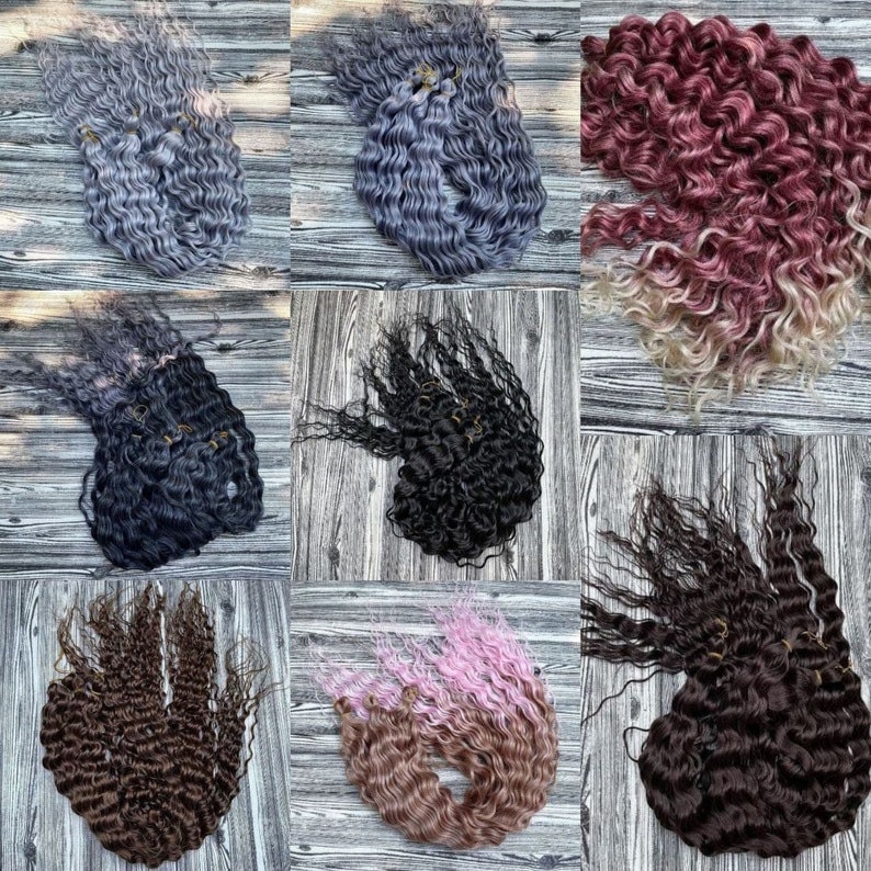 May include: Nine bundles of curly hair extensions in various colors, including black, brown, gray, pink, and red. The hair extensions are arranged in a grid pattern on a wooden surface.