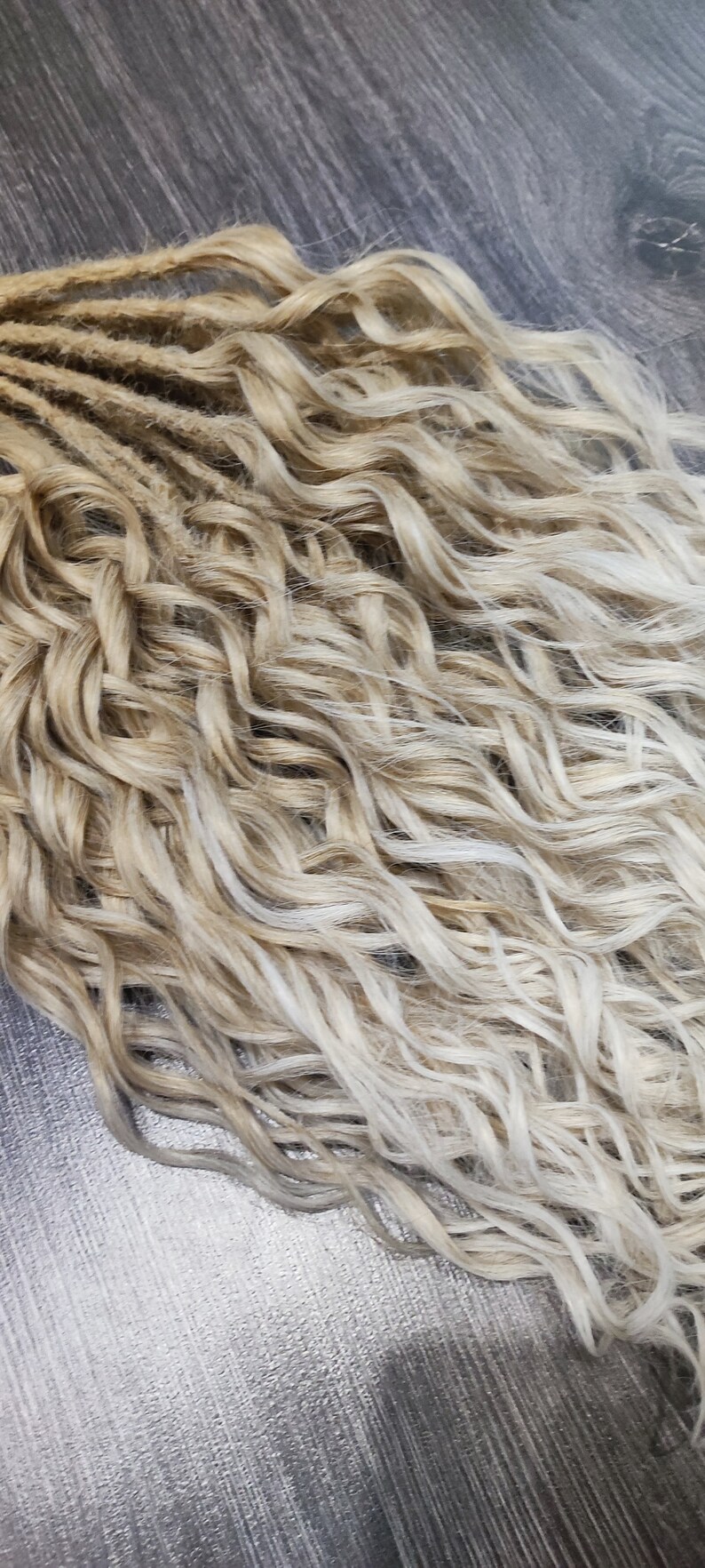 May include: A bundle of wavy blonde and light blonde synthetic dreadlocks.