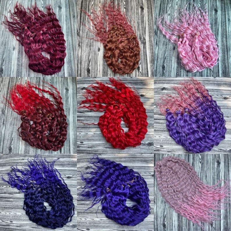 May include: A collection of nine bundles of curly hair extensions in various colors, including red, pink, purple, and blue. The hair is arranged in a grid pattern on a wooden surface.