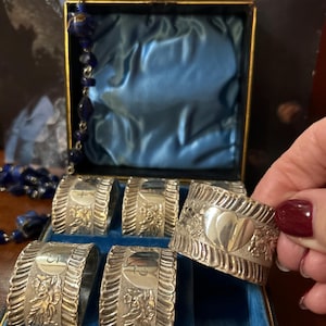 A Cased Set of Six Silverplate Napkin / Serviette Rings