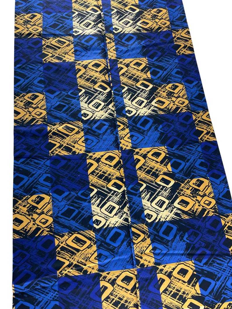 May include: A rectangular fabric piece featuring a repeating checkered pattern of deep blue and metallic gold squares. Each square contains a textured, abstract design of overlapping lines and geometric shapes in contrasting blue and gold tones.
