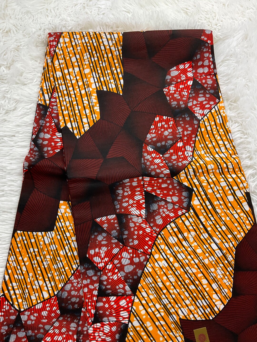 Black and Gold Ankara Wax Print Fabric with Wavy Line Field and Triangle Border Motif