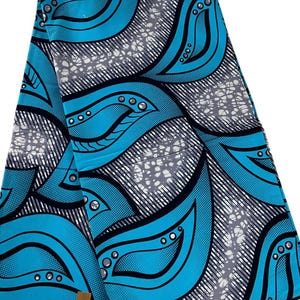 May include: A length of fabric featuring a vibrant cyan blue and black graphic pattern. The design consists of large, stylized leaf-like shapes outlined in black, interspersed with textured grey and white sections that resemble cracked stone or marble.