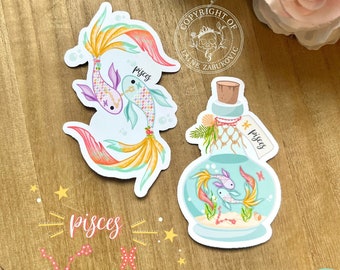 May include: Two colorful stickers featuring a Pisces zodiac sign. One sticker shows two fish swimming in a glass bottle with a cork stopper. The other sticker shows two fish swimming with a tail that resembles a mermaid's tail. Both stickers have the word "Pisces" written on them.