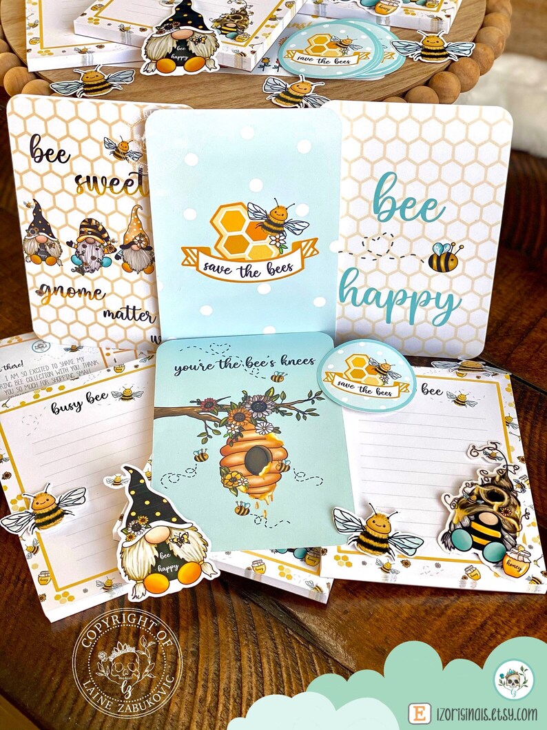 May include: A set of bee-themed stationery featuring gnomes, bees, and honeycomb designs. The stationery includes notepads, stickers, and a small round sticker with the text "save the bees".