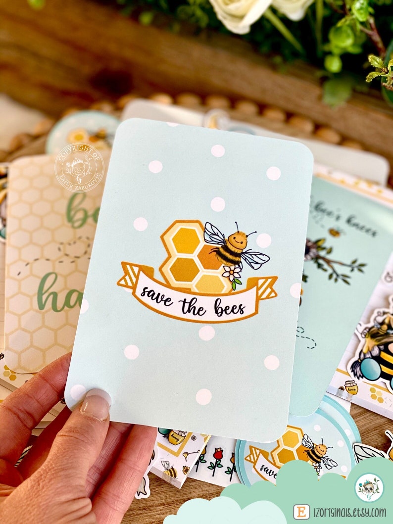May include: A light blue card with white polka dots features a cartoon bee with a honeycomb and a banner that reads "save the bees".