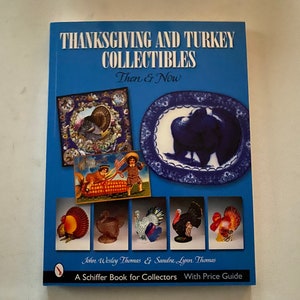 May include: A blue book titled "Thanksgiving and Turkey Collectibles: Then & Now" with a price guide. The cover features images of Thanksgiving-themed items, including a turkey, a plate, and a cornucopia.