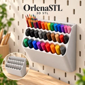 May include: A white wall-mounted organizer with four tiered rows of slots, holding various colored pencils and markers. The text OrlenaSTL 3D STL is visible above the organizer. A smaller inset image shows the empty white organizer from a side angle.