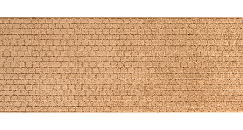 May include: A tan-colored doormat with a textured brick pattern.
