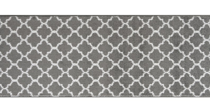 May include: A gray and white patterned runner rug with a geometric design. The rug has a subtle sheen and a soft texture.