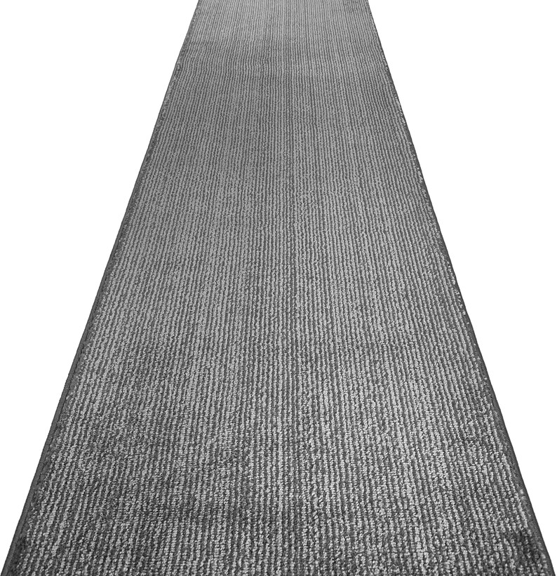 May include: A gray runner rug with a textured, ribbed surface. The rug is designed to be placed in a hallway or entryway.