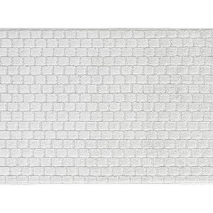 May include: White bath mat with a textured brick pattern.