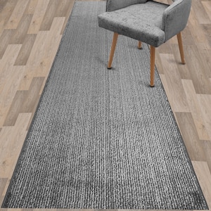 May include: A gray and white striped runner rug with a subtle sheen. The rug is placed on a wood floor and a gray chair is sitting on top of the rug.