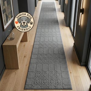 May include: A long, rectangular gray runner rug featuring a repeating geometric pattern of interconnected circles and squares. A circular badge in the upper left corner displays a dog illustration with the text SENIOR DOG FRIENDLY.