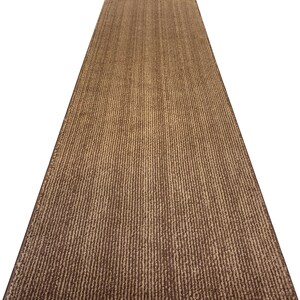May include: A brown and beige striped runner rug with a textured surface.