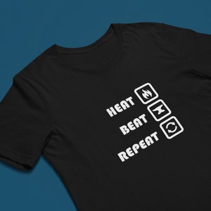 May include: Black t-shirt with white text that reads "HEAT BEAT REPEAT" with icons of a flame, an anvil, and a circle arrow.