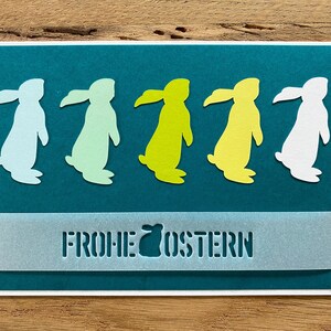 Osterkarte weiß petrol türkis farbige Osterhasen Gruß Frohe Ostern Karte