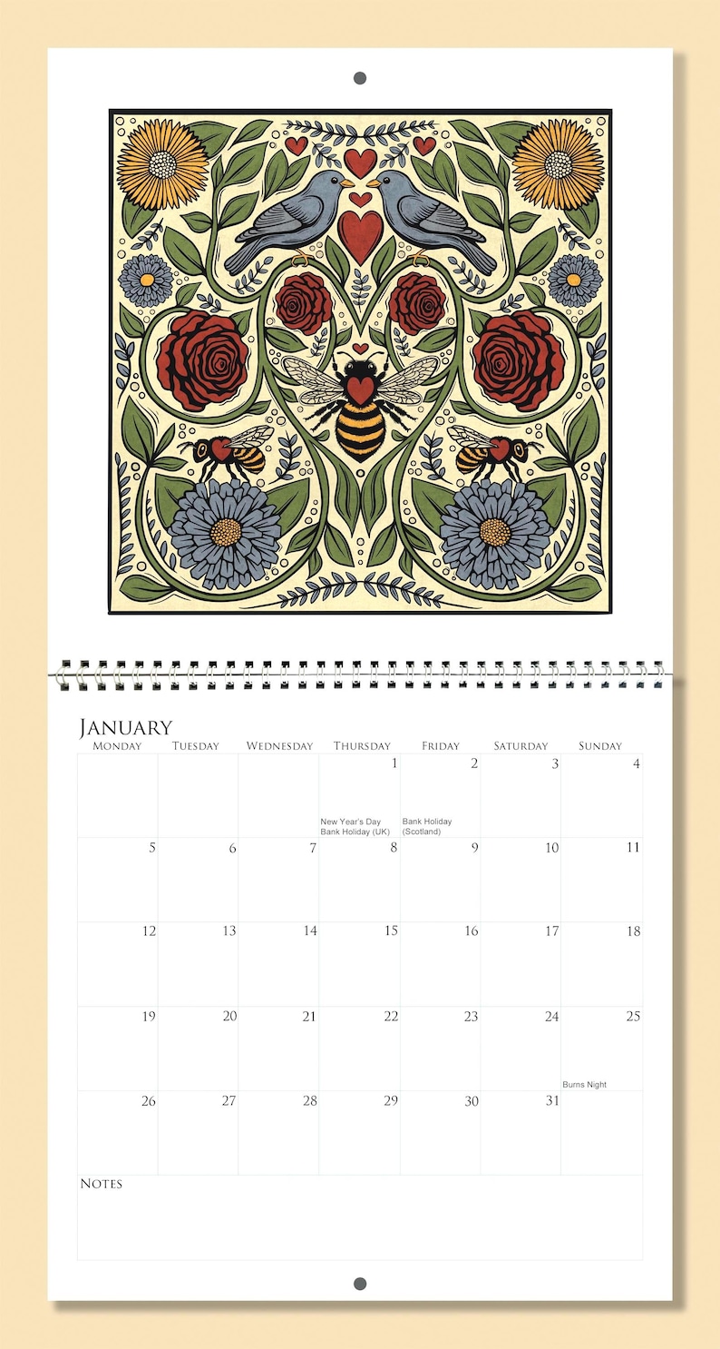 Op de afbeelding: Januari wandkalender met een decoratief bloemenontwerp met vogels, bijen en harten. De kalender heeft een spiraalbinding en bevat de dagen van de week en de data.