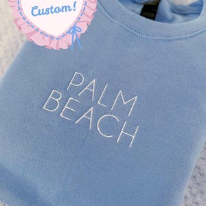 May include: A rustic wooden sign with the text "Welcome to our home" in white lettering. The sign features a distressed finish and a simple, inviting design, perfect for front door decor.