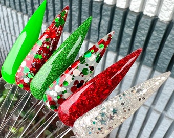 May include: Five different nail dip powders in a variety of colors and glitter finishes. The colors include green, red, white, and silver. The text "Very Merry Collection" is visible at the bottom of the image.