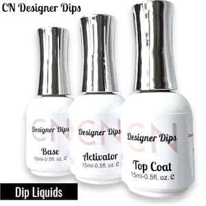 May include: Three clear bottles with silver caps labeled "CN Designer Dips" with the words "Base", "Activator", and "Top Coat" on each bottle. Each bottle contains 15 ml (0.5 fl. oz.) of liquid.