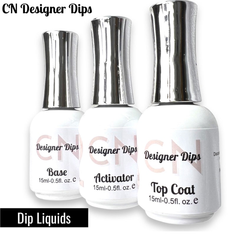 May include: Three clear bottles with silver caps labeled "CN Designer Dips" with the words "Base", "Activator", and "Top Coat" on each bottle. Each bottle contains 15 ml (0.5 fl. oz.) of liquid.