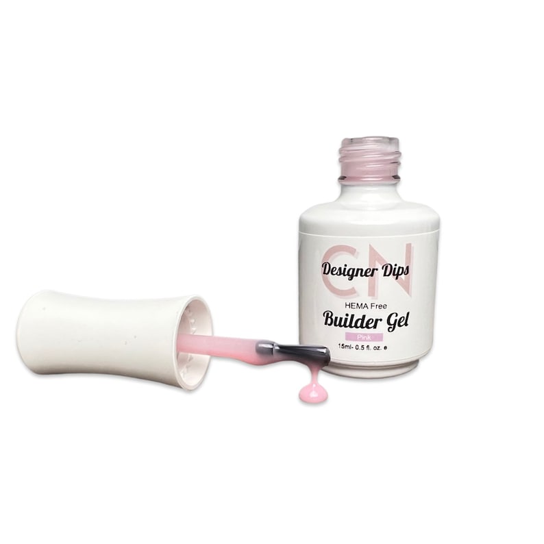 May include: A pink bottle of Designer Dips HEMA Free Builder Gel, 15ml (0.5 fl oz). The bottle has a white label with black text and a white cap. The bottle is open and a pink gel is dripping from the brush.