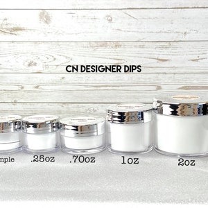 May include: Five clear acrylic jars with silver lids, labeled "Sample", ".25oz", ".70oz", "1oz", and "2oz". The jars are filled with a white substance. The text "CN DESIGNER DIPS" is printed at the top.