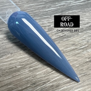 May include: A close-up of a blue nail dip powder, with a glossy finish. The powder is called "Off-Road" and is from CN Designer Dips.