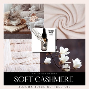 May include: A bottle of Jojoba Juice cuticle oil with a white label and black text that reads "Jojoba Juice Cuticle Oil". The bottle is sitting on a white knitted fabric background with a white flower in the background.