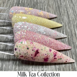 May include: Five nail dip powder colours in a milk tea collection. The colours are a light pink with gold flakes, a light yellow with gold flakes, a light pink with white glitter, a light pink with pink glitter, and a light pink with pink and green glitter.