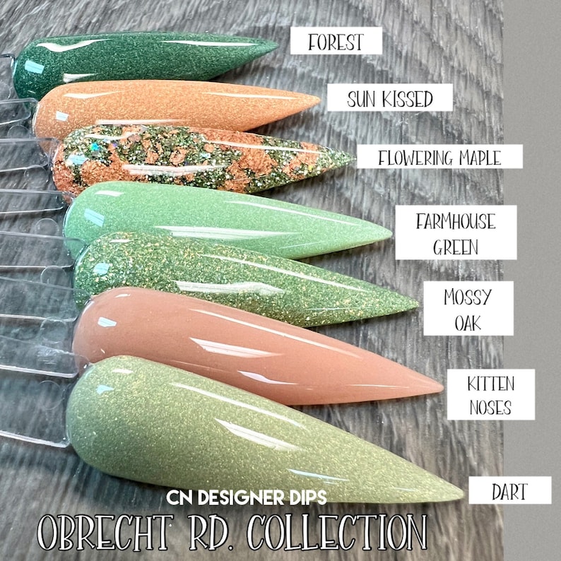May include: A set of ten nail dip powder colors in a variety of green and peach shades. The colors are labeled "Forest", "Sun Kissed", "Flowering Maple", "Farmhouse Green", "Mossy Oak", "Kitten Noses", and "Dart". The set is labeled "CN Designer Dips Obrecht RD. Collection".