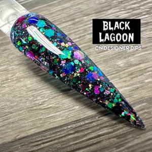 May include: Black Lagoon nail dip powder with a black base and colorful glitter. CN Designer Dips.